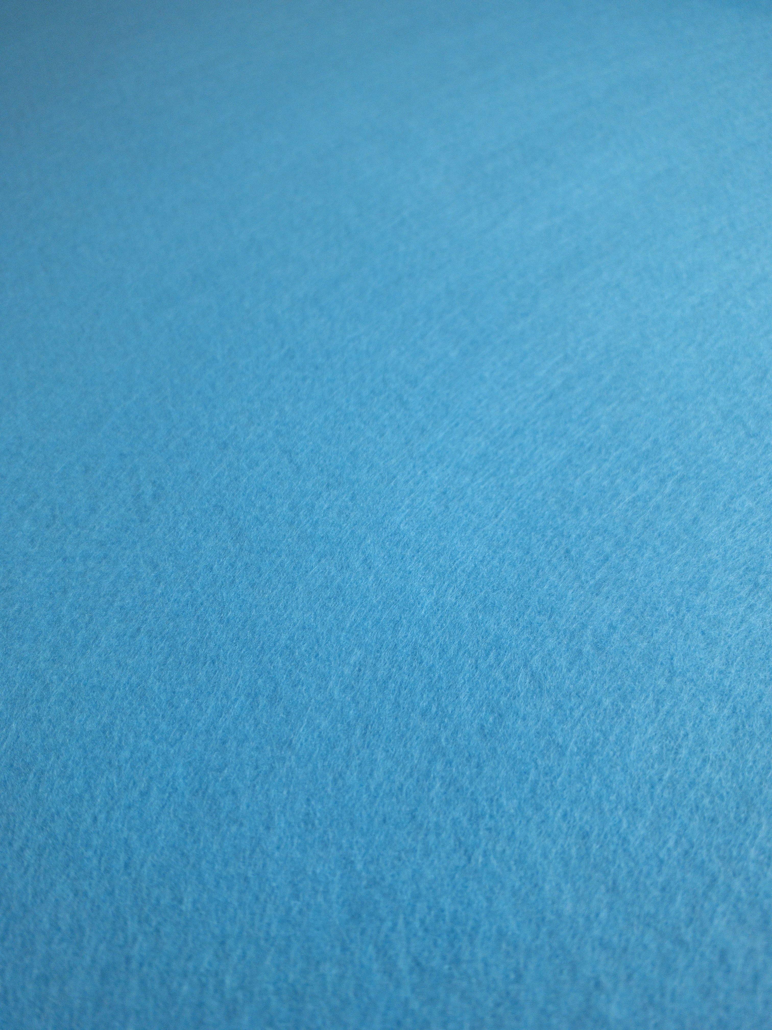 Blue felt fabric. Blue felt texture. Blue blank surface. Photos